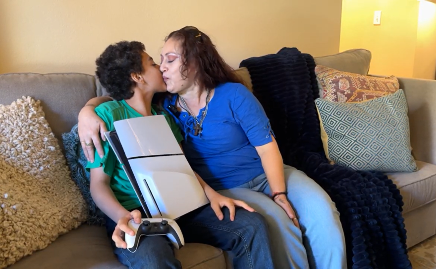 Rita Chavez and her son Dominick share a sweet moment after their "Day of Joy," in their Chula Vista, CA apartment, thanks to Humble Design San Diego on Dec. 12, 2024.