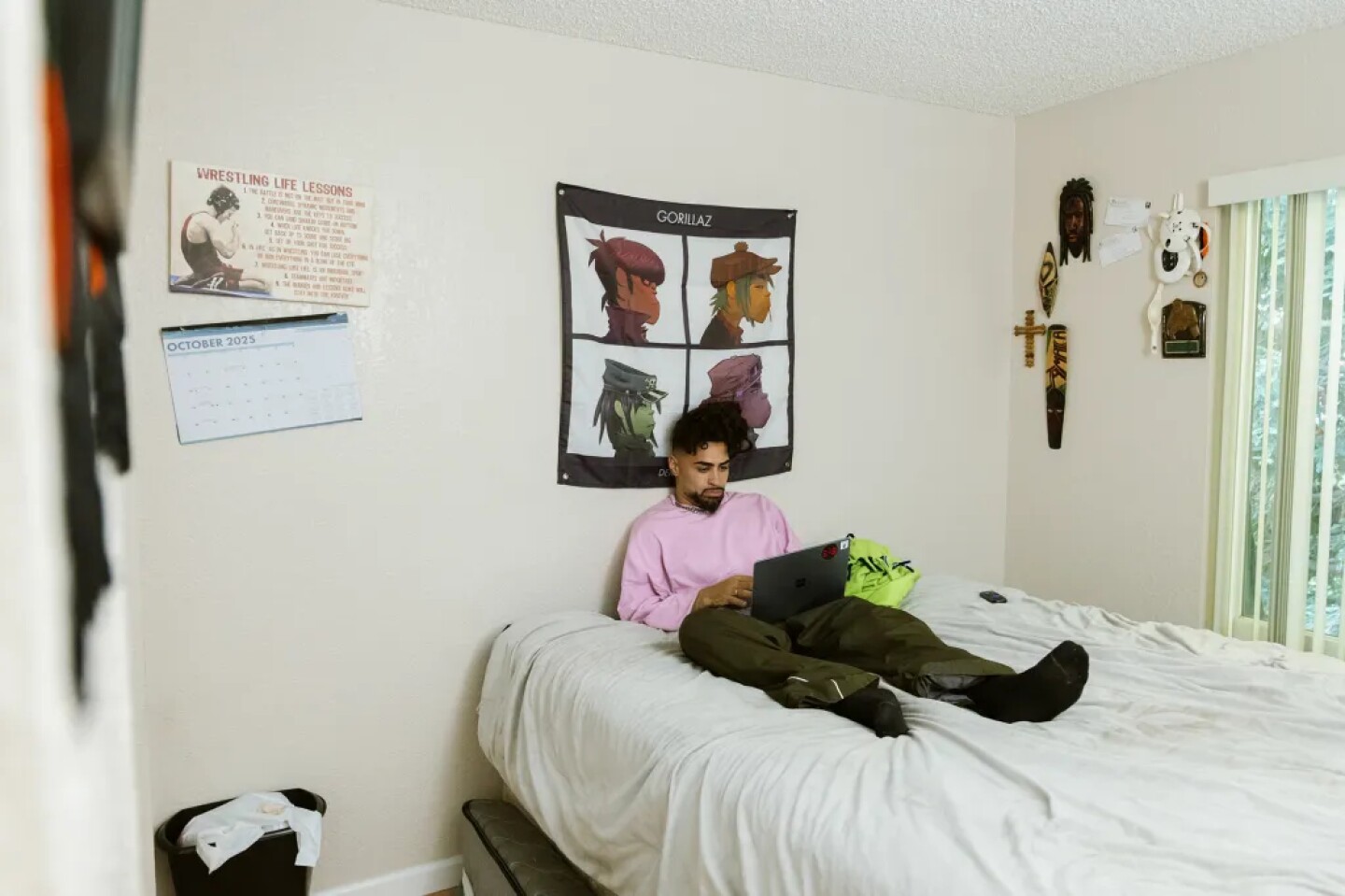 First: Jodeah Wilson sits on his bed while using his laptop in his off-campus apartment on Oct. 17, 2025.