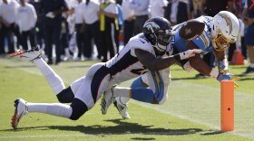 Denver Broncos defensive back Kareem Jackson, left, forces a fumble by Los Angeles Chargers running back Austin Ekeler at the goal line during the first half of an NFL football game Sunday, Oct. 6, 2019, in Carson, Calif.