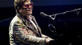 Elton John performs during his "Farewell Yellow Brick Road" tour on Jan. 19 in New Orleans. Despite being vaccinated and boosted, John has contracted COVID-19 and postponed two farewell concert dates in Dallas. John "is experiencing only mild symptoms," according to a statement.