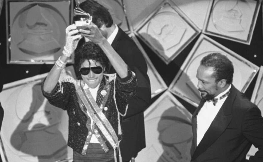 Michael Jackson, left, holds up his Grammy for Best Album of the Year as Quincy Jones looks on, in 1984. Rod Temperton wrote three of the hit songs for Jackson's smash album Thriller.