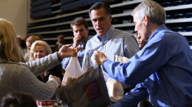Republican presidential candidate, former Massachusetts Gov. Mitt Romney accepts a food donation from a supporter during a Kettering Storm Relief event on October 30, 2012 in Kettering, Ohio. 