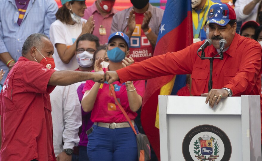 Diosdado Cabello (left), a candidate in Venezuela's upcoming National Assembly elections, bumps fists with Venezuelan President Nicolás Maduro during a closing campaign rally in Caracas, Venezuela, on Thursday. Venezuelans will vote for a new National Assembly on Sunday.