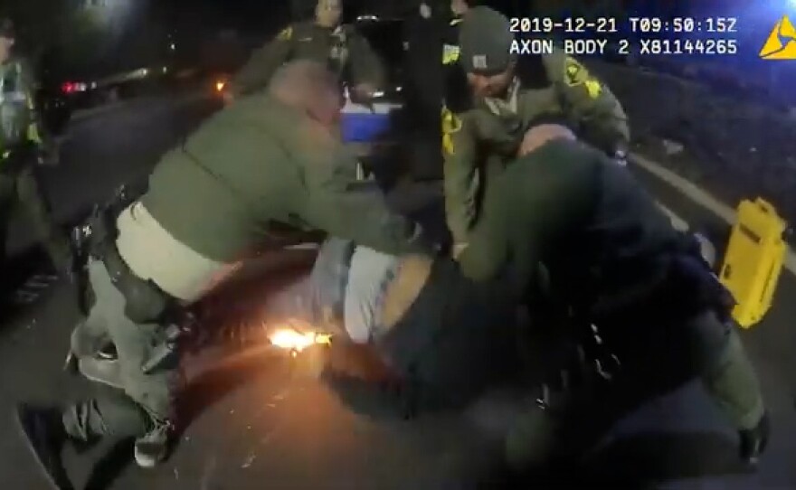 A screenshot of body camera footage released by the San Diego County Sheriff's Department that shows deputies subduing Joe Young on Dec. 21, 2019. Young was tased three times and the taser ignited a lighter in his pocket started a fire. Young was later treated for his injuries at a hospital and the charges against him were dismissed.