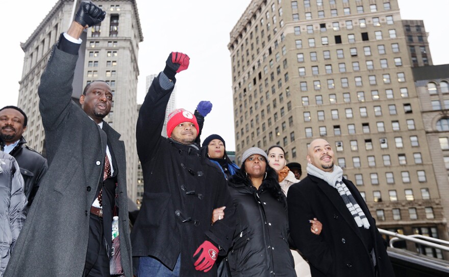 In this Jan. 17, 2012 file photo, Yusef Salaam, left, Kevin Richardson, second left, and Raymond Santana, right, react to supporters in New York. The three men who were exonerated in the 1989 Central Park Jogger case, were in court for a hearing in a $250 million federal lawsuit they filed against the city after their sentences were vacated. New York City has started releasing about 100,000 pages of documents connected to the notorious case of the five men whose convictions for raping and beating a Central Park jogger were overturned after they served more than a decade behind bars.