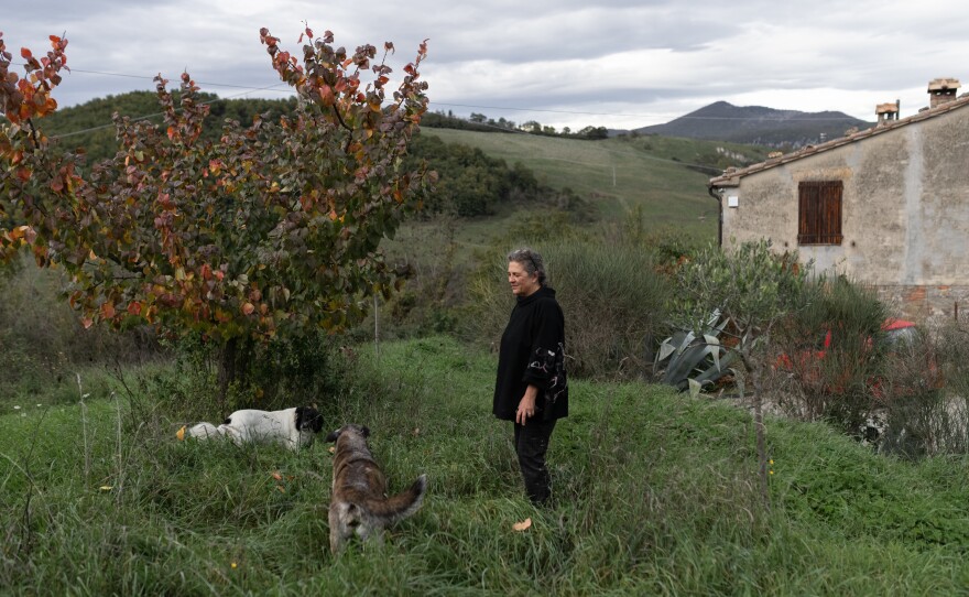 Gloria Lucchesi stands in the yard of her house, on Nov. 12, in San Casciano dei Bagni.