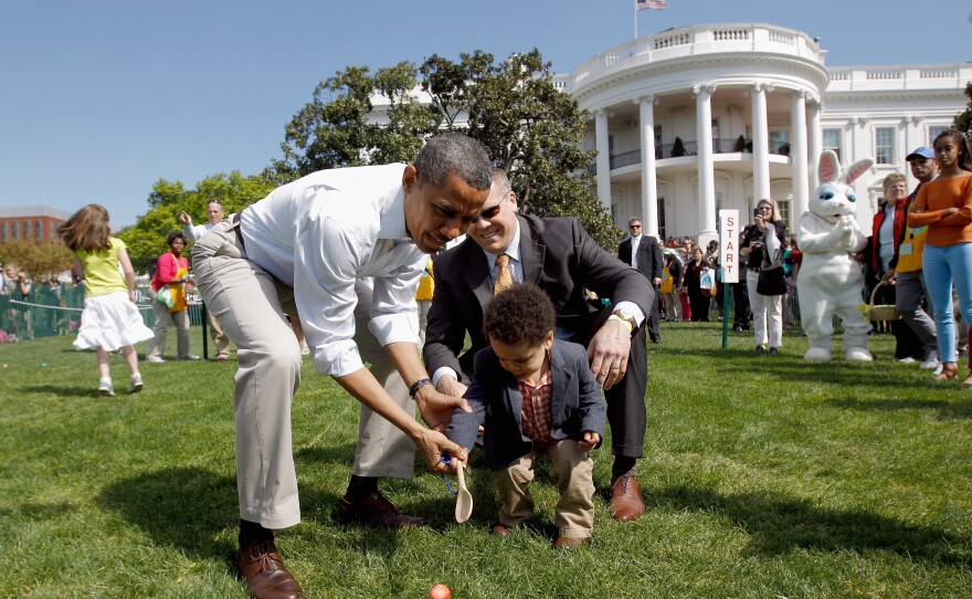 President Obama helps a young participant roll an egg during the 2012 White House Easter Egg Roll on the South Lawn. This year's event will take place Monday.