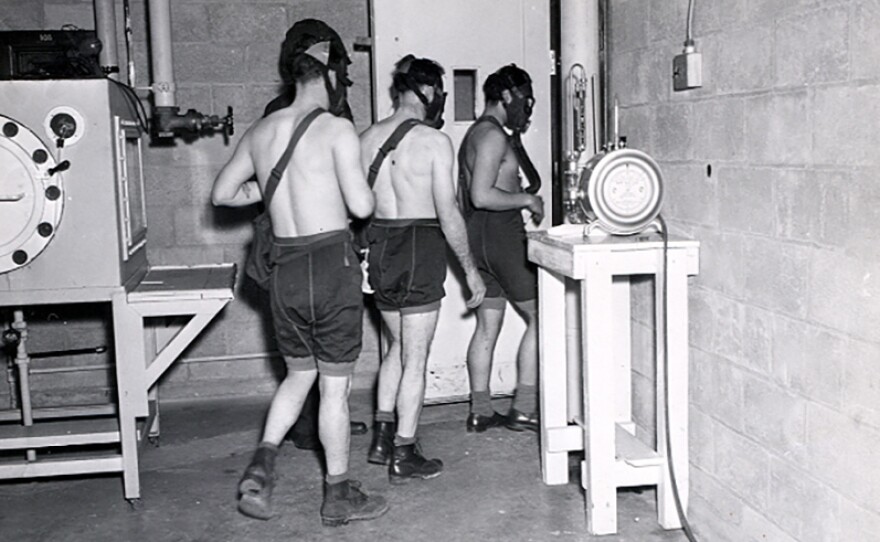 Three test subjects enter a gas chamber, which will fill with mustard gas, as part of the military's secret chemical warfare testing in March 1945.