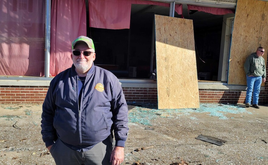 Dennis Brasher stands in front of his ruined hardware store in Dawson Springs. "I lost it in thirty seconds," he said. "Worked all my life for it and lost it in a matter of minutes."