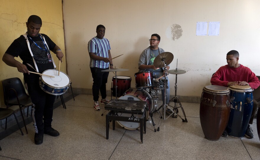 American musicians Darnell Simms and Jason Williams (left) from the Trombone Shorty Foundation teach at the Amadeo Roldan Conservatory as Cuban students Landi Peña Gonzalez and Jonathan Mendoza Valle (right) play along.