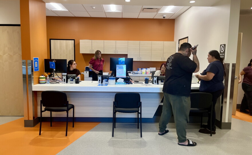 People stand near the front desk at the Santee Animal Shelter, Oct. 15, 2026.