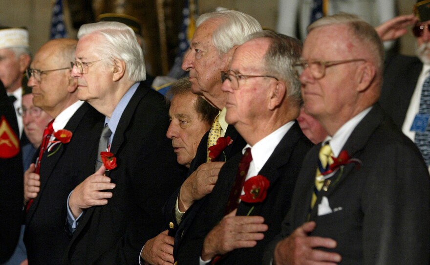 Rep. John Dingell (from left), D-Mich., Rep. Henry Hyde, R-Ill., Rep. Ralph Regula, R- Ohio, Rep. Ralph Hall, D-Texas, Rep. Cass Ballenger, R-N.C., and Rep. Amo Houghton, R-N.Y., stand at a House ceremony honoring World War II veterans in 2004.