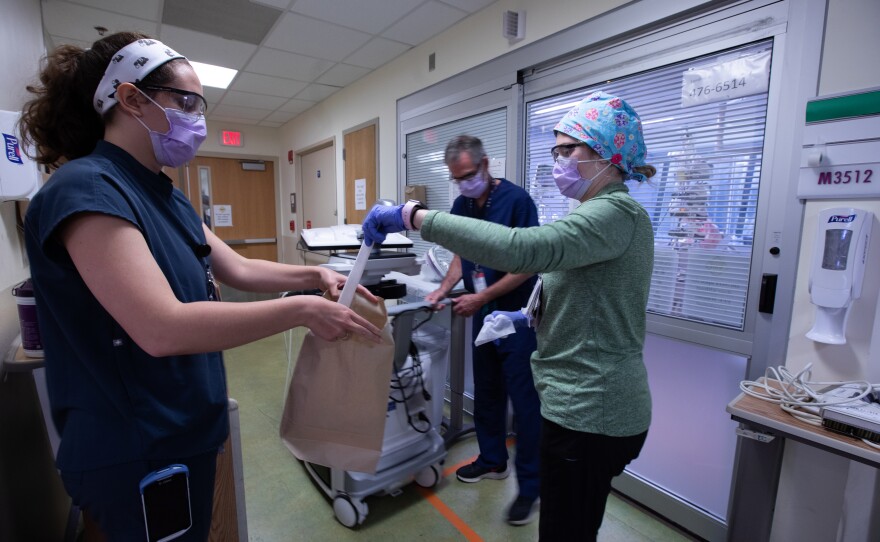 Nurses from the pediatric intensive care unit put away protective equipment in order to sanitize it after being used by a staff member at the Children's National Hospital.