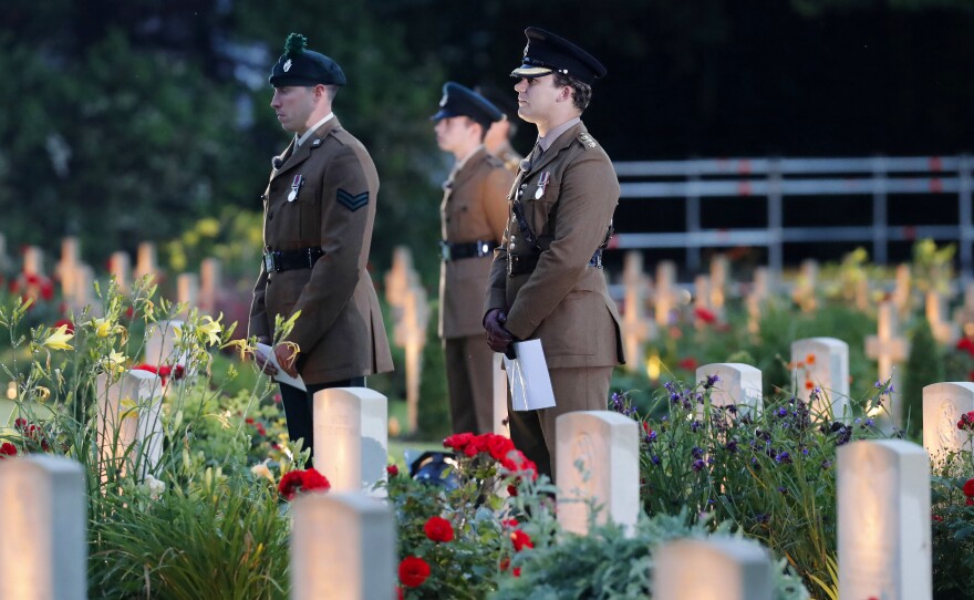 British soldiers stand among graves as they attend a vigil Thursday to commemorate the 100th anniversary of the beginning of the Battle of the Somme in northern France.