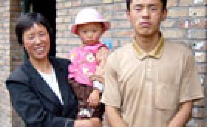 Wang Bin, his mother and niece outside their home on Route 312 in central China.