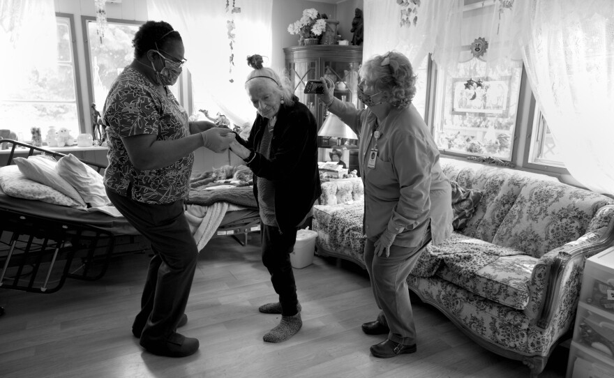 Chaplain Charlotte Keys holds an iPhone and blasts Gudrun Johnston's favorite dance music, while Jetton takes her for a twirl to celebrate her birthday on April 23, 2020. Taking off their personal protective equipment for the party is an uncommon exception to their typical routine.