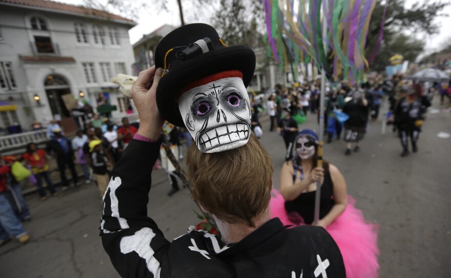 A reveler shows off his mask during the Krewe of Okeanos parade in New Orleans on Feb. 10, 2013.