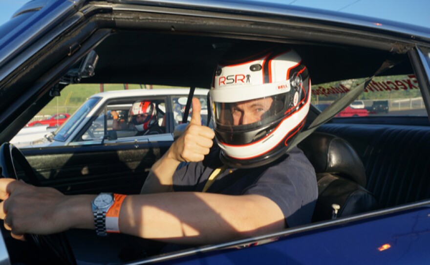 David Pogue gets ready to race in sports car.