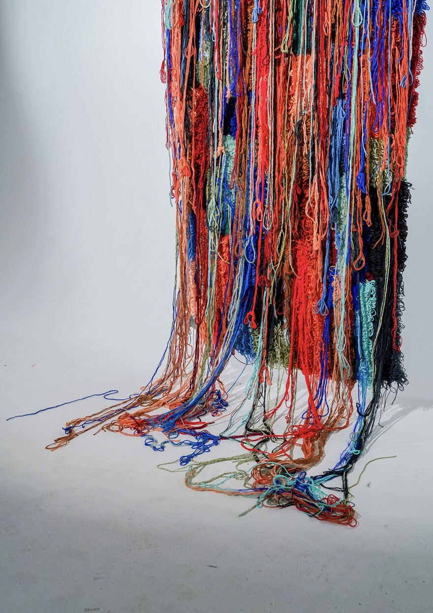 Denja Harris' "Stop Suffering Today!" is a 2023 work of yarn, cloth and felt backing.