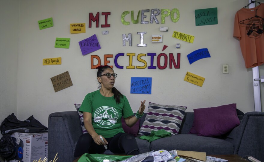 Crystal Perez Lira, from the "Colectiva Bloodys y Projects," gives an interview at her office where the wall reads in Spanish "My body, my decision," in Tijuana, Mexico, Thursday, Sept. 28, 2023. Lira is one of dozens of Mexican volunteers who support women wanting to terminate a pregnancy, offering virtual guidance through an abortion protocol in which no clinics or prescriptions are needed.