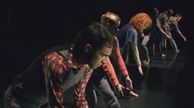 A performance photo of dancers. Troika Ranch, an award-winning international dance company struggles to create a new, experimental dance work exploring the repetitions of the modern world in which ordinary people find themselves trapped in "Loopdiver: The Journey Of A Dance."