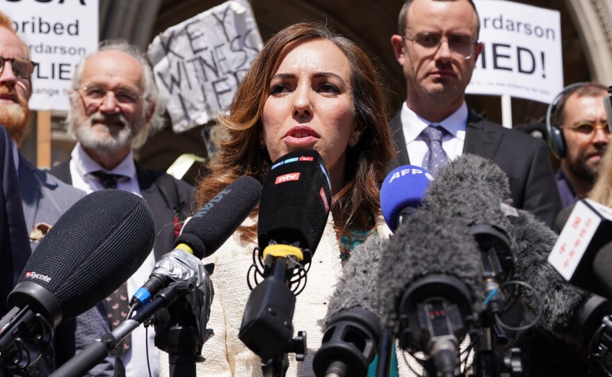 Stella Assange, the wife of Julian Assange, gives a statement outside the Royal Courts of Justice in London, after he won a bid at the High Court to bring an appeal against his extradition to the United States.