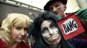 Fans dressed as Captain Marvel, from left, The Joker and Freddy Krueger attend Day One of Comic-Con International, July 21, 2016.