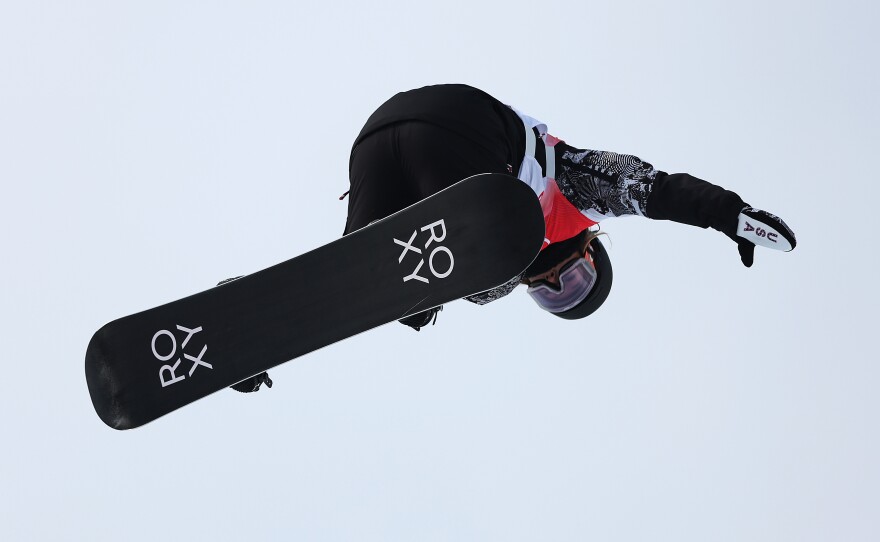 Returning snowboard halfpipe champ, Chloe Kim, performs a trick during qualification at the Beijing 2022 Winter Olympic Games.