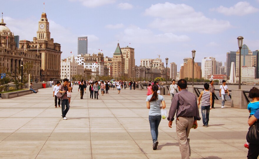 People stroll along the Bund, Shanghai's famed colonial waterfront. Shanghai enjoys considerably better air quality than Beijing, but suffocating pollution last December alarmed residents.