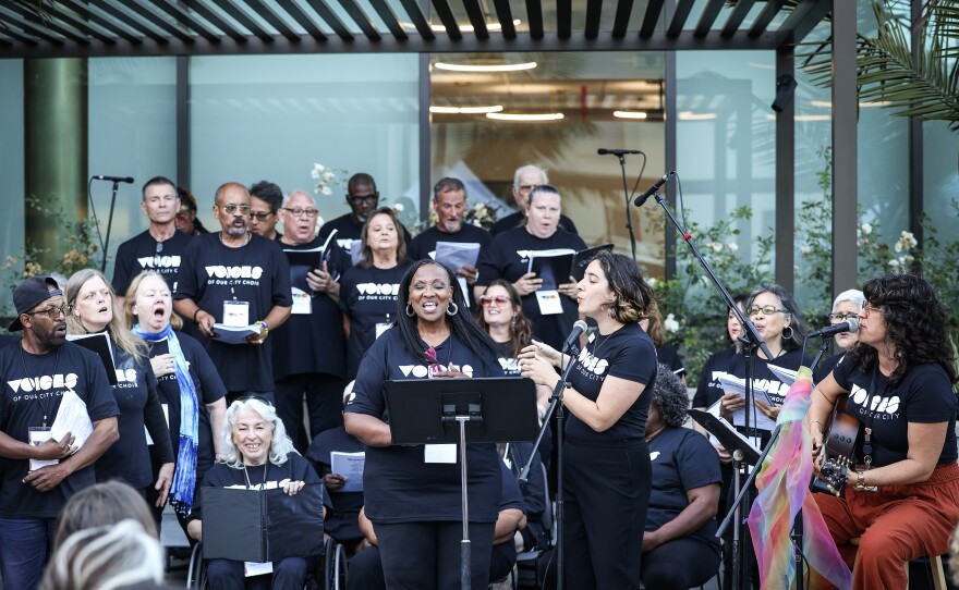 Members of Voices of Our City choir sing together in St. Paul's Episcopal Cathedral Courtyard for their Pride in Partnership event in 2024.