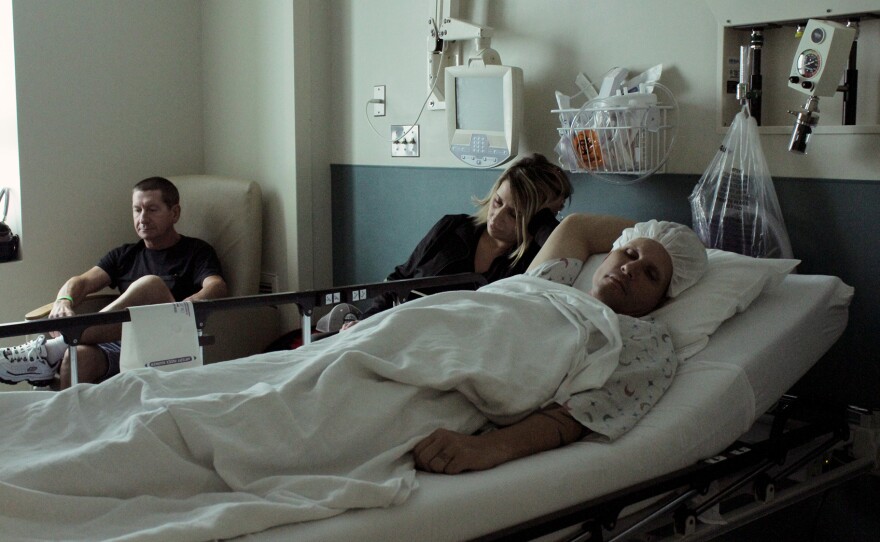 Kris Penny, his wife, Lori McNamara, and his father-in-law, Frank McNamara, at the University of Maryland Medical Center before Penny's surgery in August.