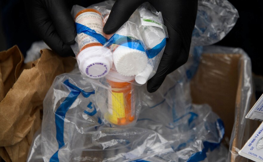 Containers of pills and prescription drugs are boxed for disposal during the Drug Enforcement Administration's 20th National Prescription Drug Take Back Day on April 24, 2021. Nearly 108,000 people died in 2021 from drug overdoses.