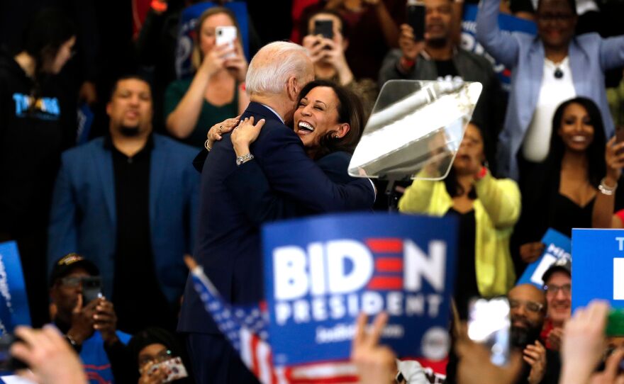 Biden hugs his former primary rival and future running mate, California Sen. Kamala Harris, after she endorsed him at a campaign rally in Detroit on March 9.