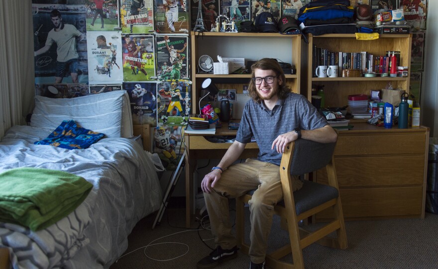 Kai Rowlands, 19, poses for a portrait in his dorm room at Marquette University in Milwaukee, on Sunday. Rowlands is an undergrad studying physics and Spanish.