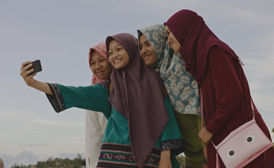 Nuha takes a selfie with friends. Teen innovators prepare for the largest convening of high school scientists in the world.