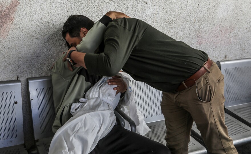Ahmed Barhoum, displaced and now in Rafah, holds the body of his daughter Alaa, 5, at a morgue on April 20. Israeli airstrikes the night before killed the child, her mother and seven other people, most of them children sheltering in a home in Rafah.