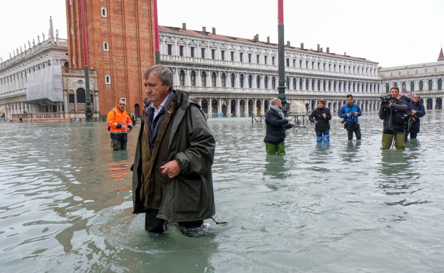 Venice Mayor Luigi Brugnaro trudges through high water in St. Mark's Square on Wednesday, the result of an exceptionally high tide in the scenic Italian city.