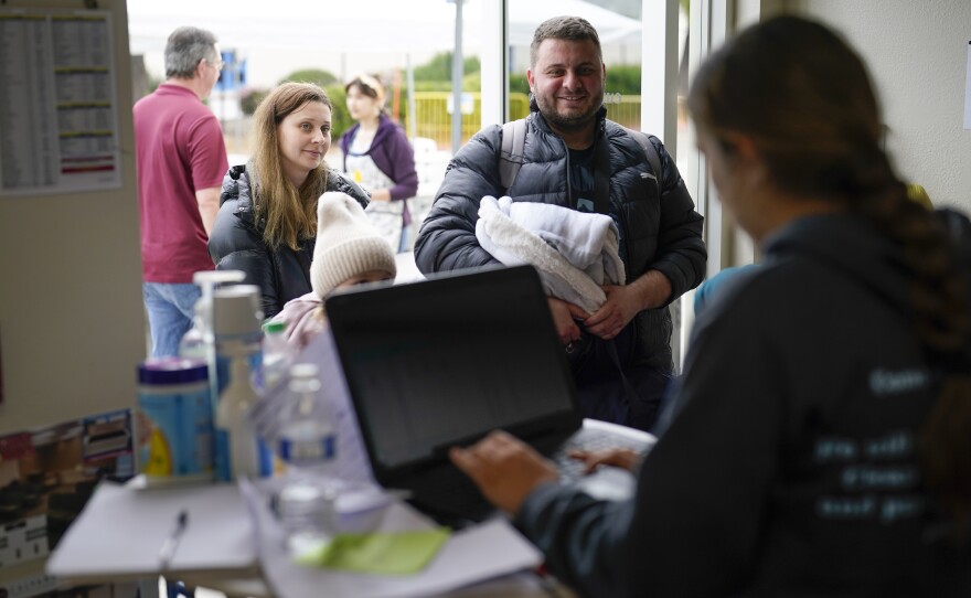 A family from Ukraine arrive to a shelter at the Christian church Calvary San Diego, after crossing into the United States from Tijuana, Mexico, Friday, April 1, 2022, in Chula Vista, Calif.