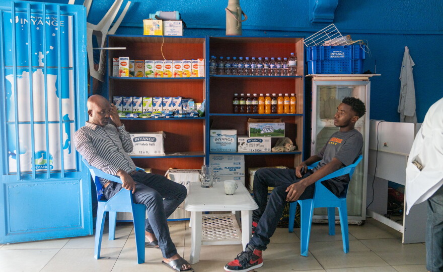 Gilly Claude Uwizeyamana (left) and Gilles Bertrand Niyomwungeri take a milk break. The Rwandan custom is to sit down when drinking milk, out of respect for cows, which are seen as symbols of prosperity.