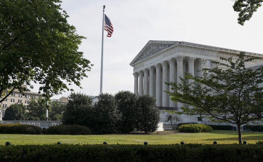 The U.S. Supreme Court building, pictured in June. Legal experts and election officials say the 14th Amendment question is likely to end up in the courts.