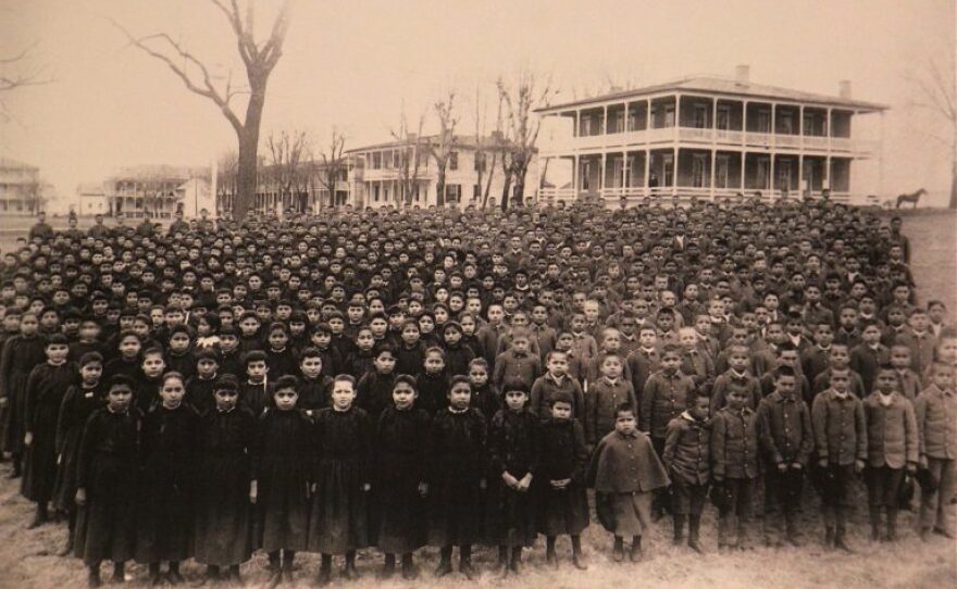 The students of the Carlisle Indian School are amassed on the grounds of the school in March of 1892.