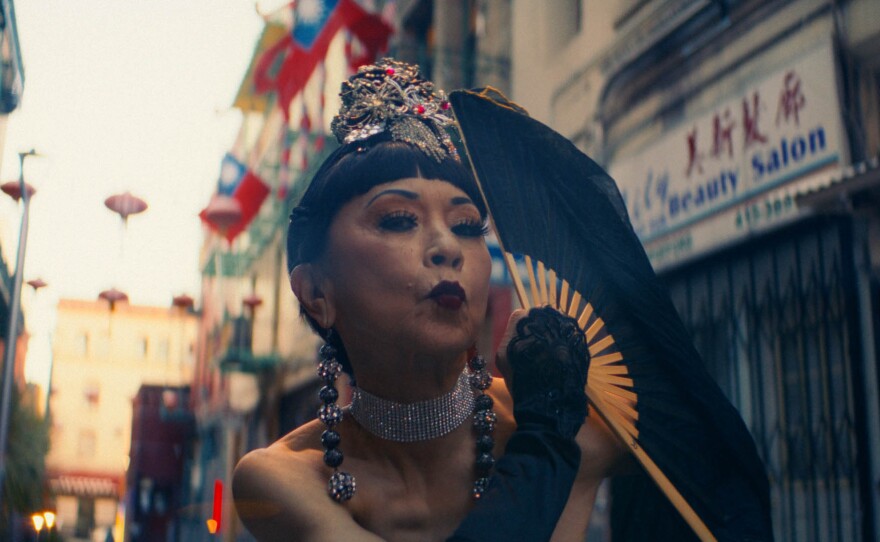 Clara Hsu, member of the Grant Avenue Follies, poses with her fan.