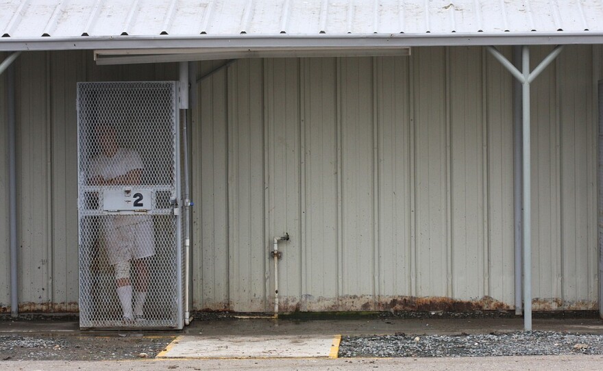 An inmate waits in a temporary holding tank before being moved to another location at the Richard J. Donovan state prison in Otay Mesa.