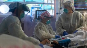 Scripps Health registered nurse Christina Campolongo (left), certified nursing assistant Vanessa Aquino and registered nurse Paloma Garza-Johnson turn a sedated coronavirus patient into the prone position, face down, which may allow more oxygen into the patient’s lungs. June 2020 at Scripps Mercy Hospital Chula Vista.