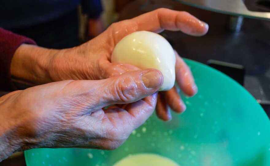 Kathy Fields, owner of Flint Hill Farm, demonstrates how to form a mozzarella ball.