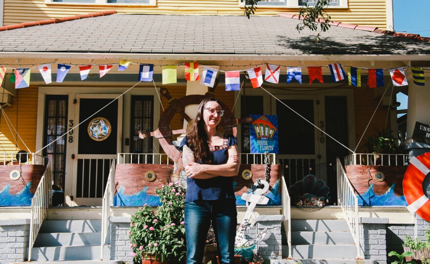 Megan Boudreaux, founder of Krewe of House Floats, stands outside her own home and the 'USS House Float,' in Algiers Point. "It's a little surreal how we got to this place," Boudreaux said.