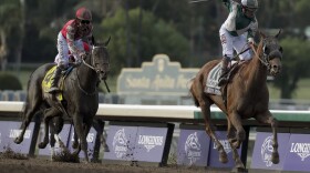 Joe Bravo, right, aboard Blue Prize celebrates after winning the Breeders' Cup Distaff horse race at Santa Anita Park, Saturday, Nov. 2, 2019, in Arcadia, Calif. 