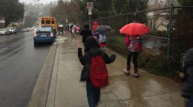 Students walk to school during a morning downpour on Dec. 12, 2014 in San Diego, California.