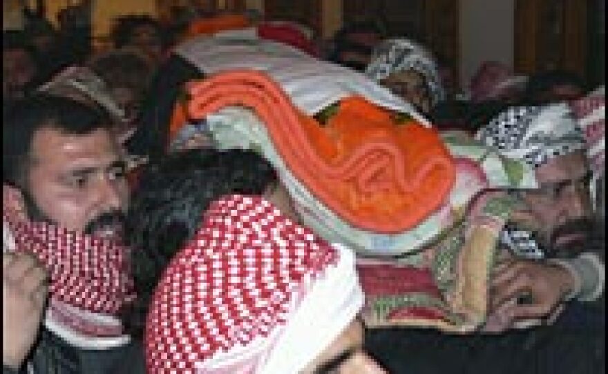 Coffins containing the bodies of Barzan al Tikriti and Awad al Bandar, aides of Saddam Hussein who were hanged, are carried out for burial, Jan. 15, 2007, in the Sunni Arab town of Awja, Iraq.