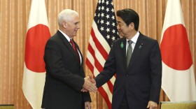 Japanese Prime Minister Shinzo Abe, right, and U.S. Vice President Mike Pence shake hands prior to a luncheon hosted by Abe at the prime minister's official residence in Tokyo, April 18, 2017. 